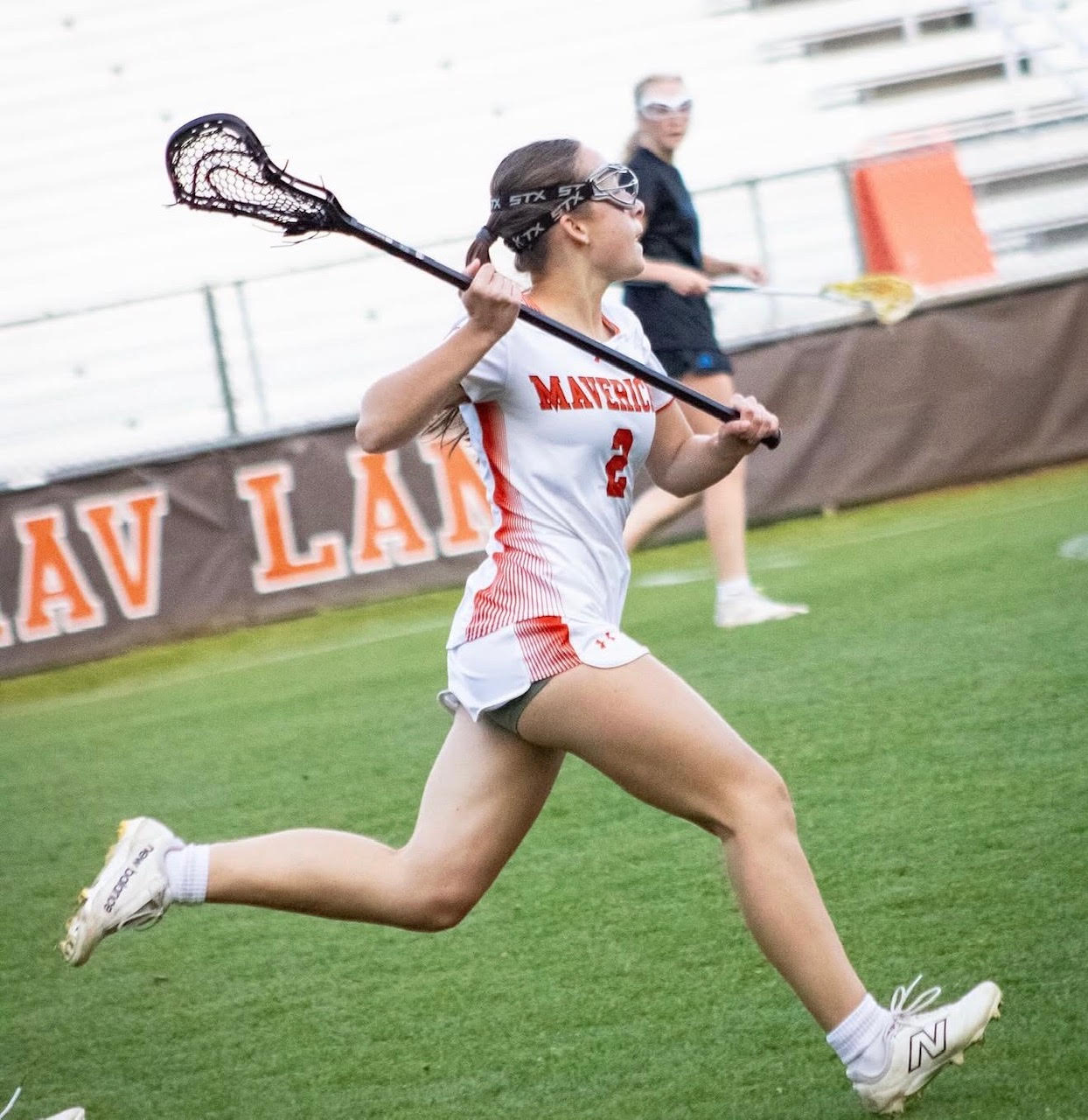 Mavericks lacrosse player sprinting downfield